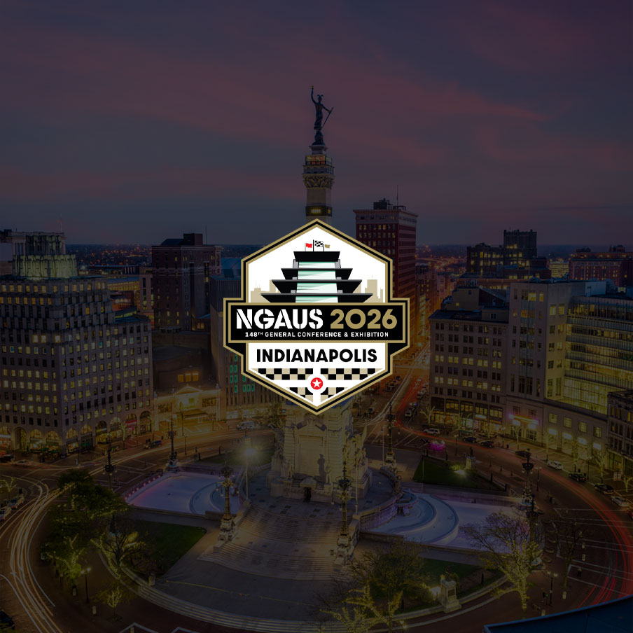 Promotional badge for NGAUS 2026 Indianapolis overlaying a nighttime cityscape.